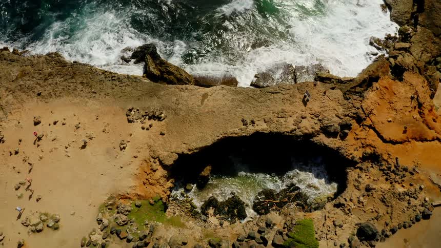 Ocean waves crashing into a shoreline in the daytime