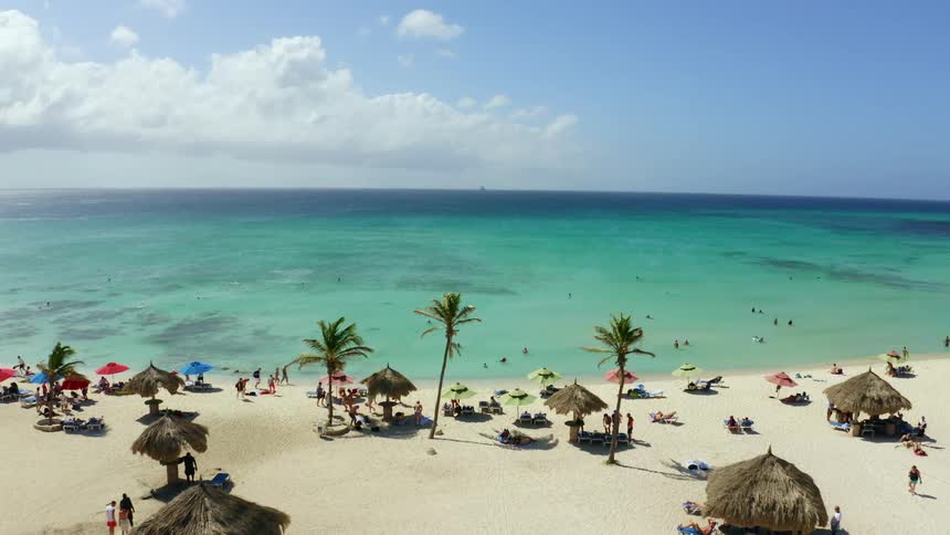 People are relaxing at a beach on a sunny day
