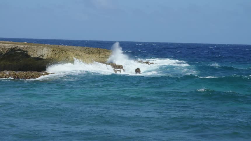Ocean waves are moving towards the island
