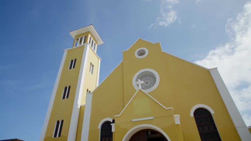 Yellow facade of a church under blue sky