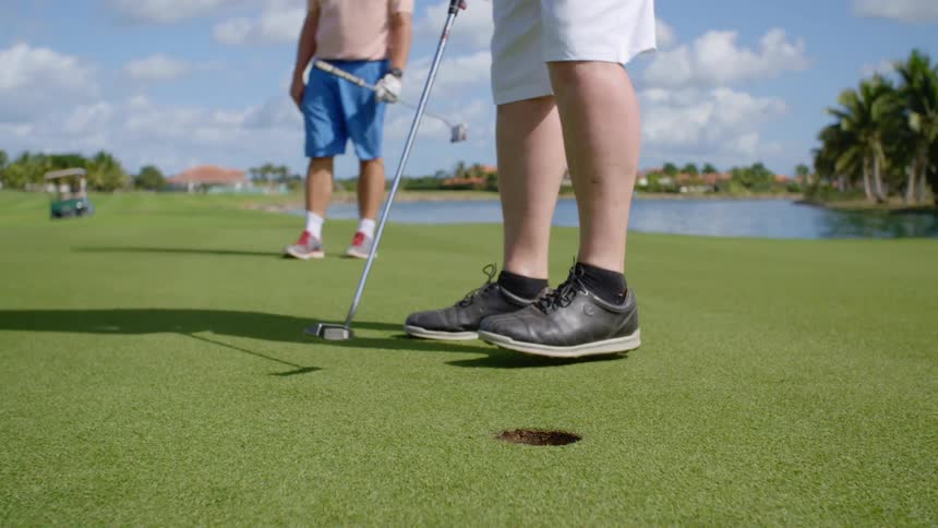 Golfers golfing on a golf course