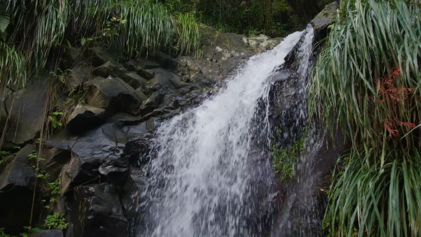 A waterfall flowing over rocks in nature