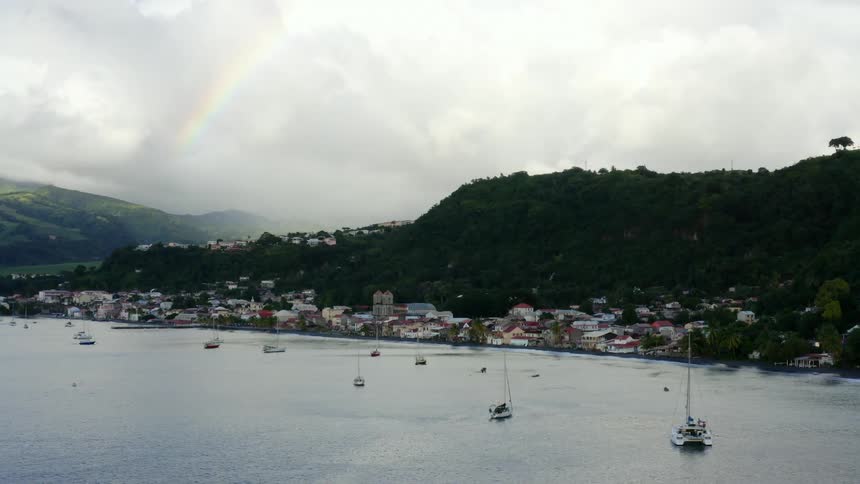 Aerial view a port with a rainbow in the sky