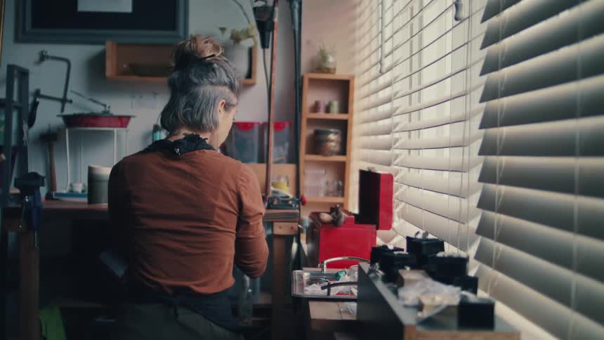 A woman at home reaches in to a toolbox