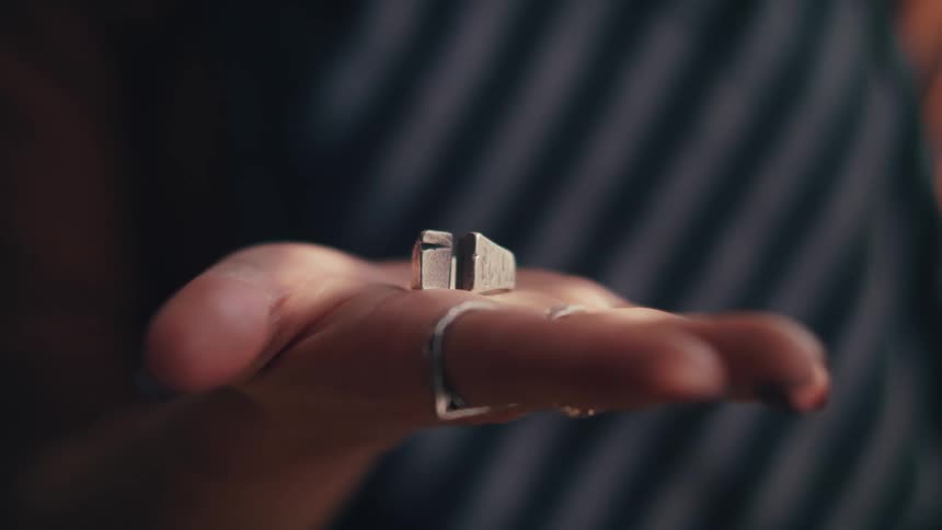Woman shows a metal ring on the palm of her hand