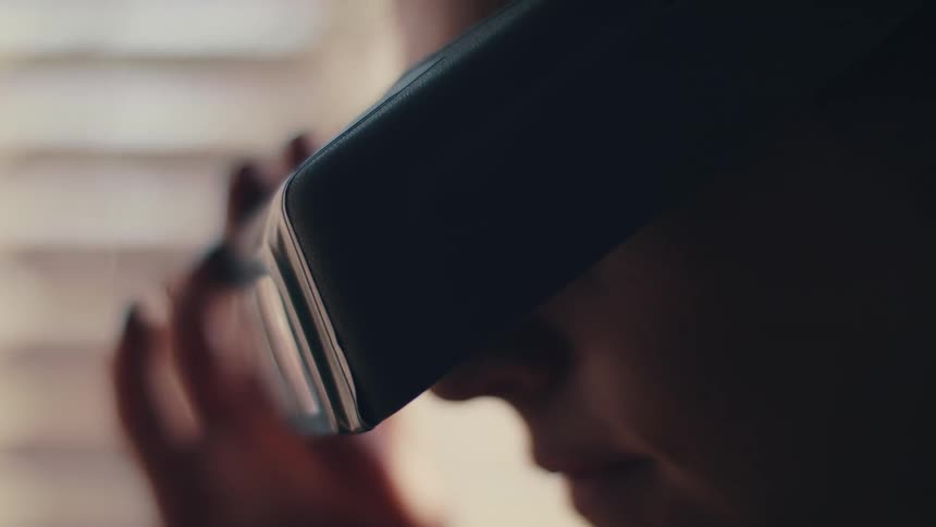 A person with glasses and goggles looking at a ring