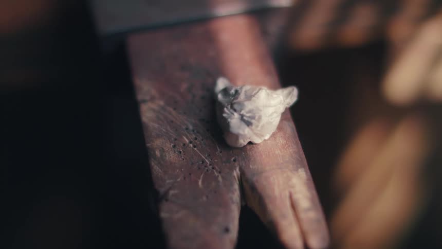 A piece of rock sitting on a piece of wood