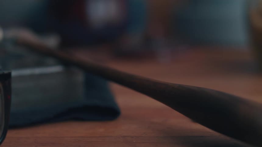 A hammer on a wood workbench indoors
