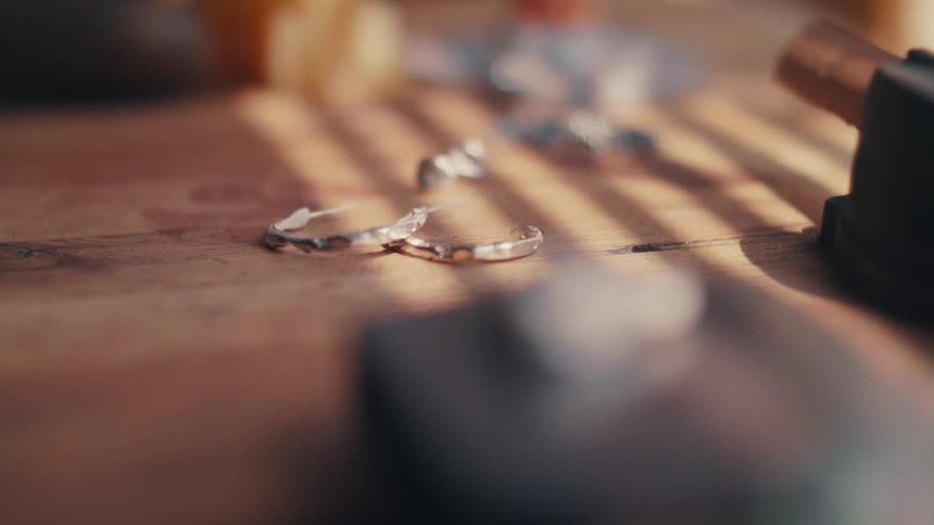 Silver earrings on a wood table