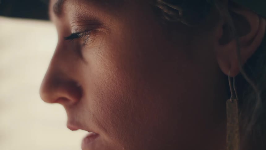 Side view of a blonde woman with earring