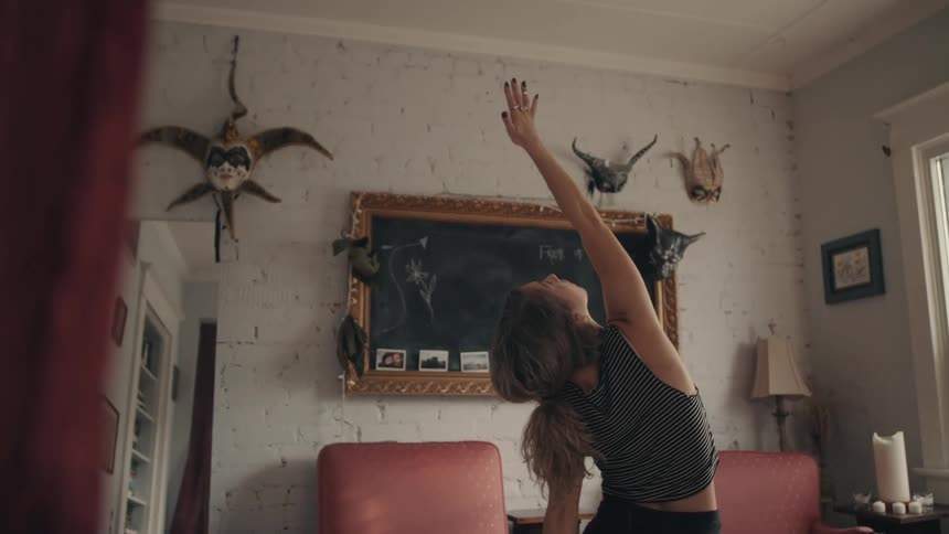Fit woman practices yoga on the living room at home