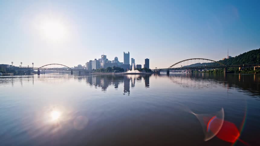 A quick zoom in of a city on a river