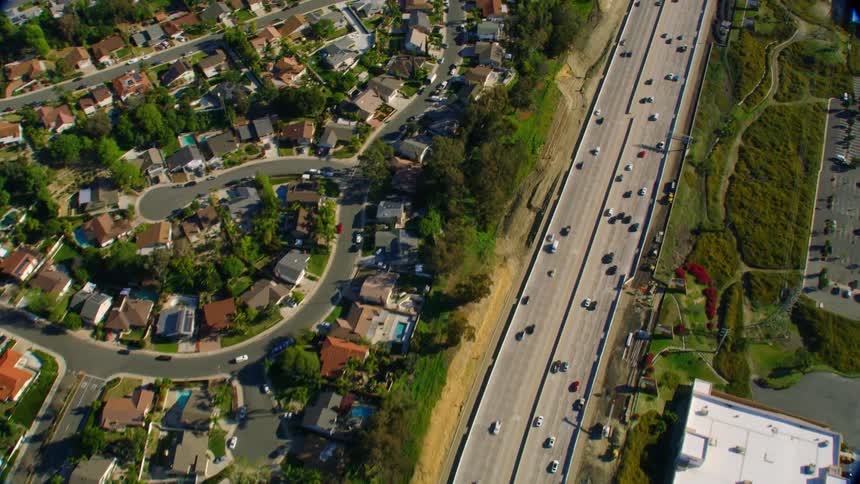 Aerial of cars racing at high speed down the freeway