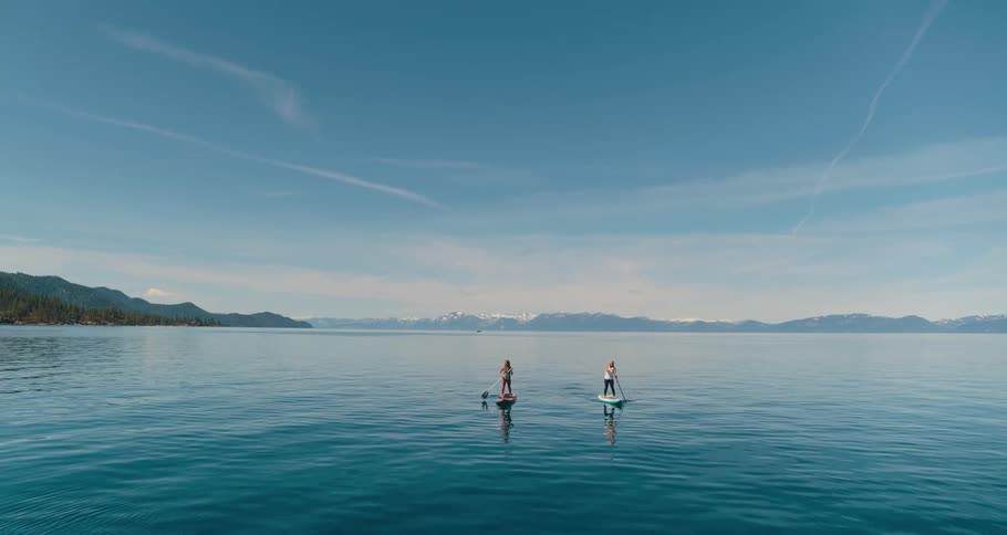 Two people on the water paddle boarding