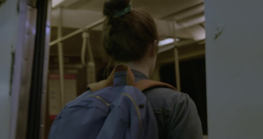 A woman walks onto a train