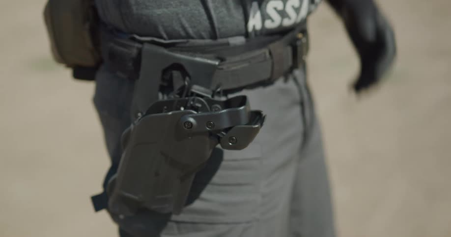 A man drawing a gun out of a holster