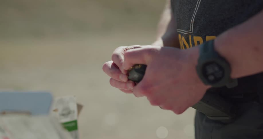 A man loads ammunition into his magazine