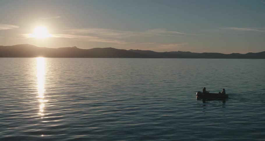 Two people on a row boat in a lake