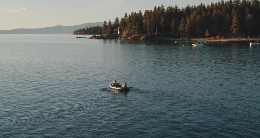 Two people in a row boat on a lake