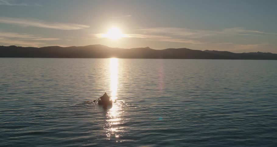 A person paddling a boat on a lake