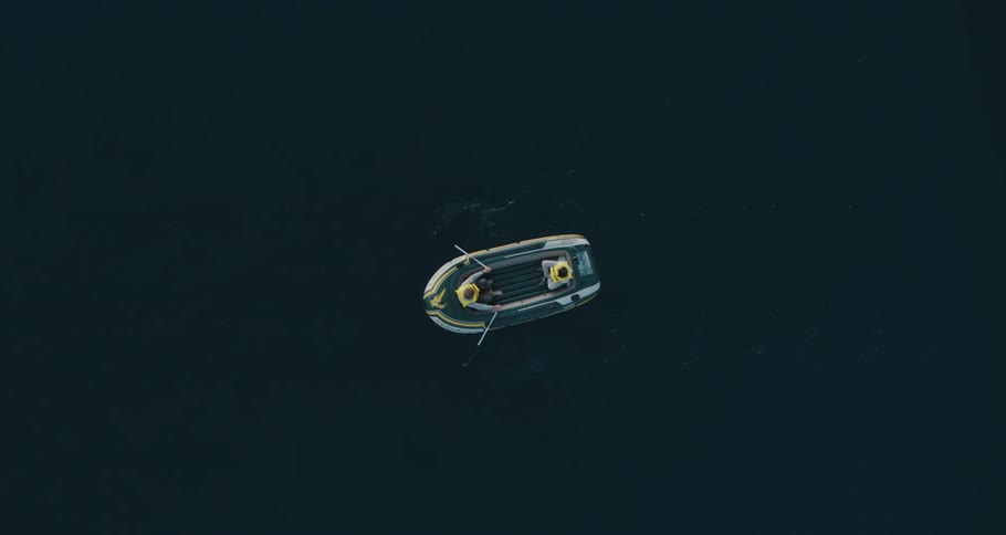 Two people riding in a rowboat on a lake