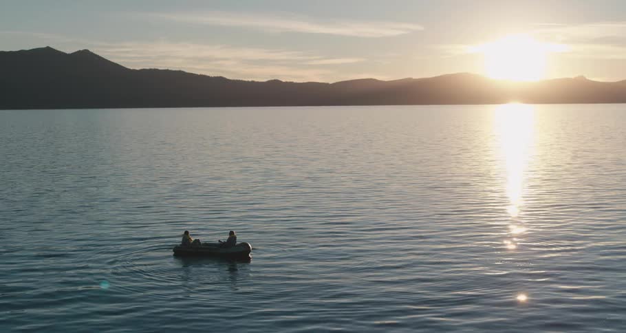 Two people in a row boat in a lake