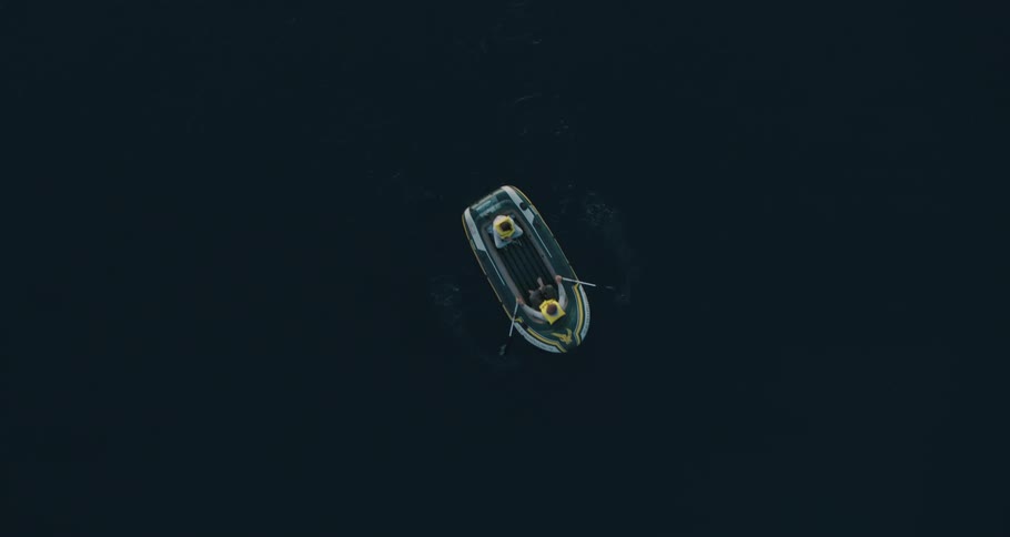 Two people in a row boat rowing on the water