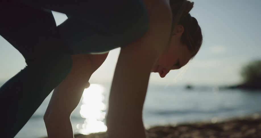 A woman doing yoga on the beach