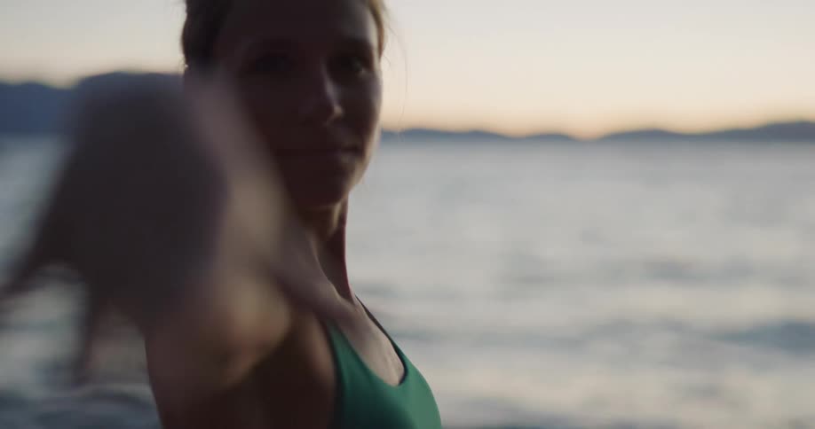 A woman is doing yoga at the beach