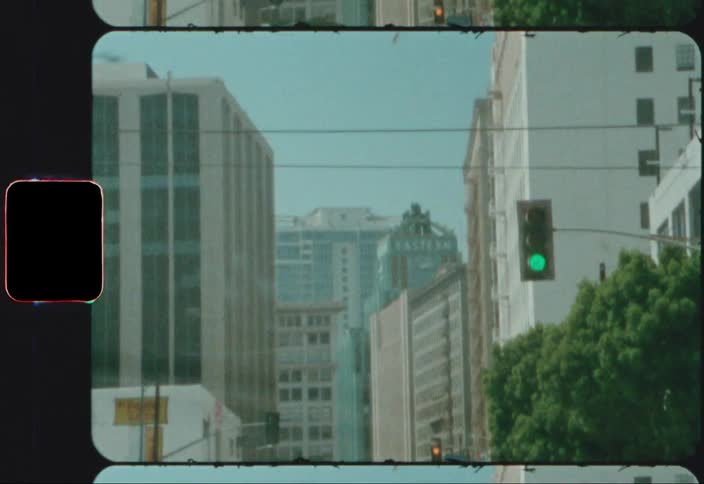 A city with vehicles streetlights trees buildings and the sky in the background