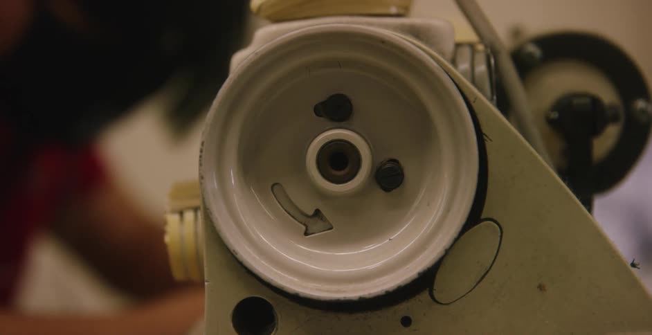 A person sewing in a factory