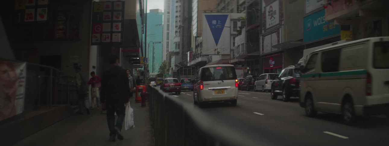 Busy downtown street with cars passing by
