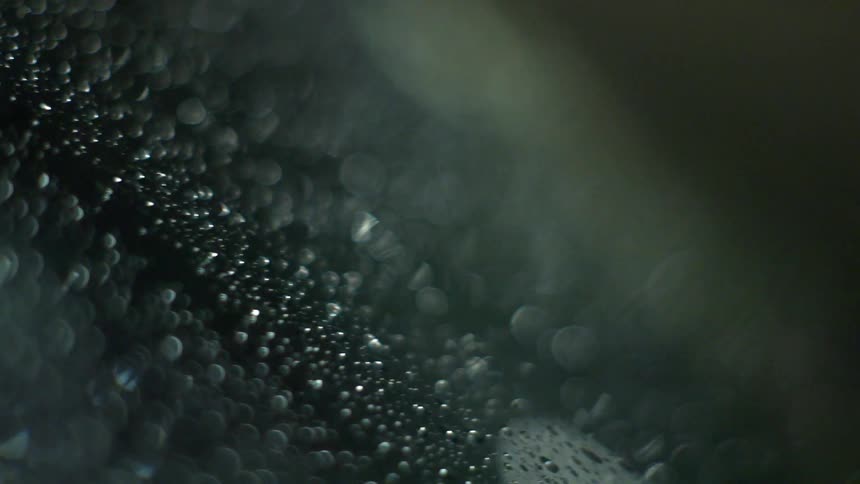 Abstract shot of lights through droplets of water