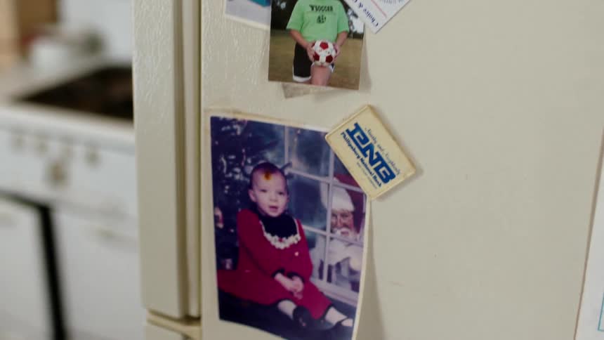 Pictures of children hang on a fridge