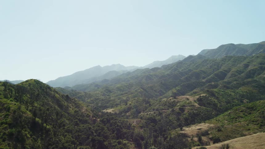An aerial view of tree covered hills and the valley