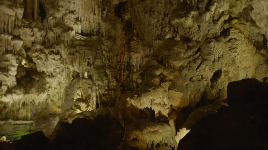 A limestone cavern illuminated by floor lights