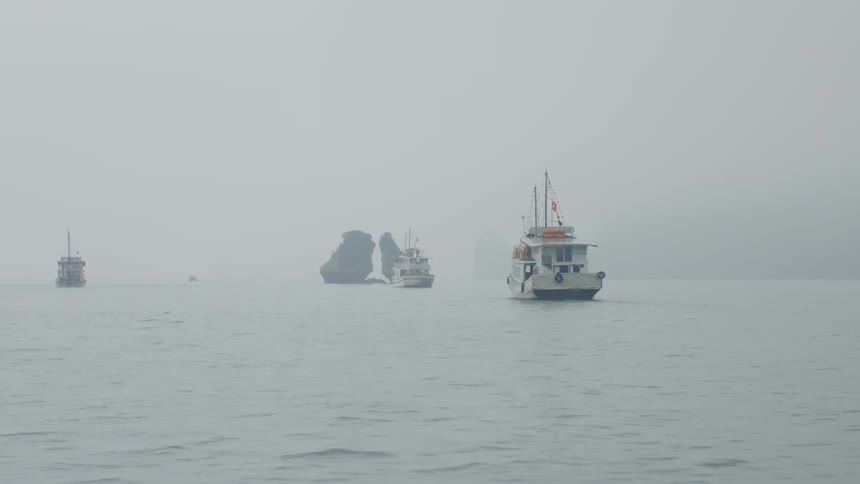 Boats in a harbor on a misty day