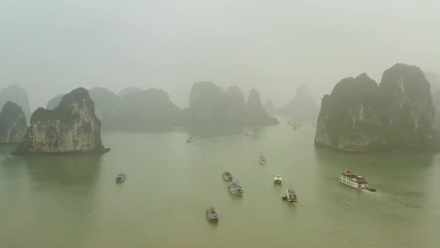 A river with boats with cliffs the sky and clouds in the background