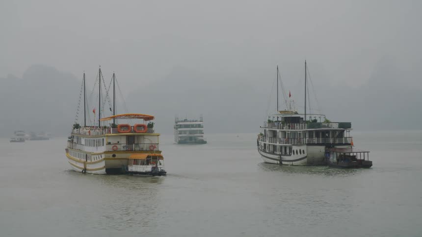 Boats on a river in the fog