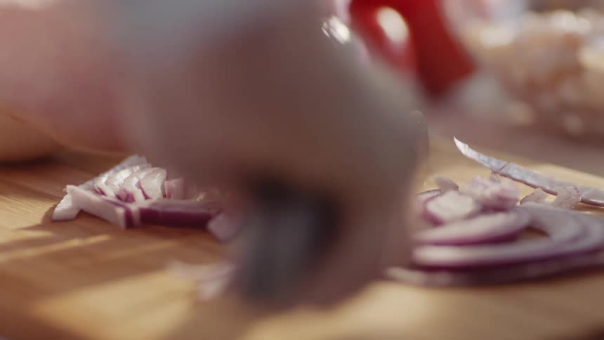 A woman chopping an onion