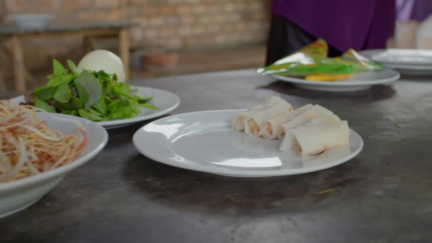 A counter covered in plates of food