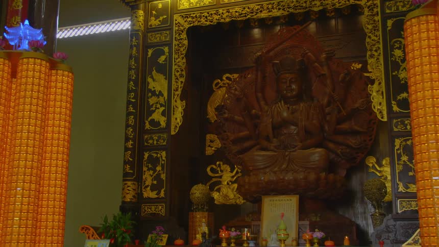A carving of buddha sits on a decorative wall