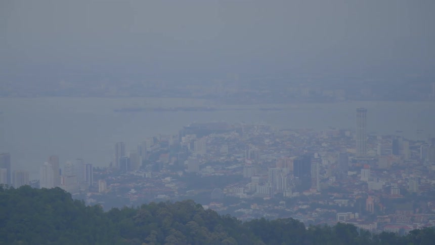 Heavy fog blankets a city along the ocean