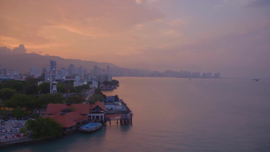 The coast of a foggy metropolis at sunset