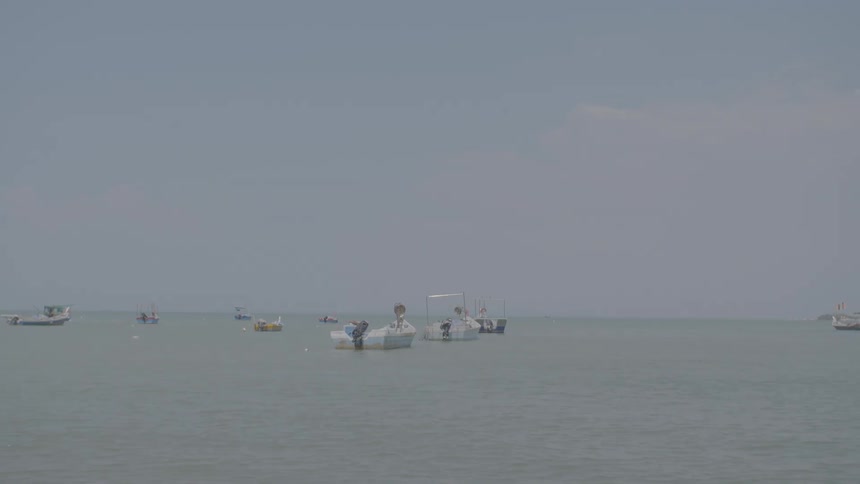 Boats floating on ocean waters in the daytime
