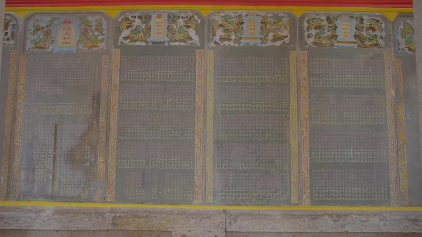 Decorated panels occupy side of building near columns
