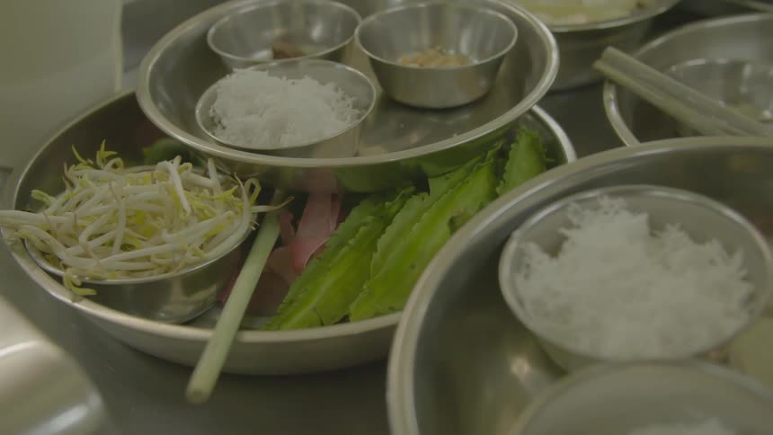 Ingredients stacked in metal bowls in a kitchen
