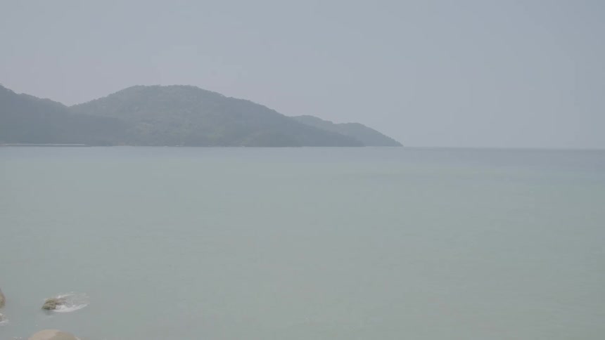 Heavy fog sets over a turquoise ocean