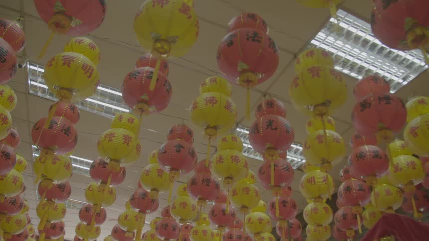 Yellow and red paper lanterns hanging from ceiling
