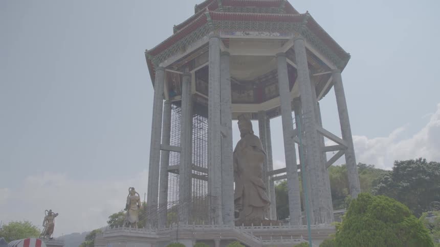 Statues at a monument surrounded by trees